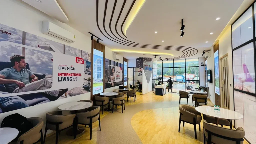Baluwala sales office in Andheri with client discussion tables, curved ceiling and project display screens