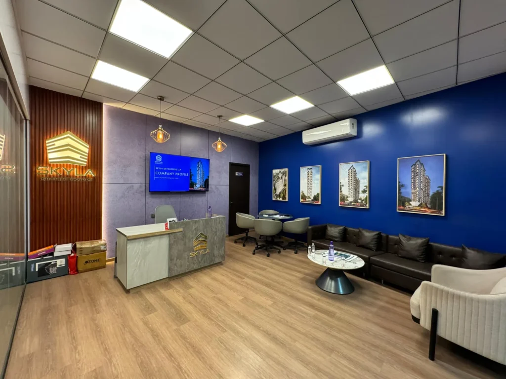 Skyla sales office interior in Dahisar with reception desk, blue feature wall and leather lounge